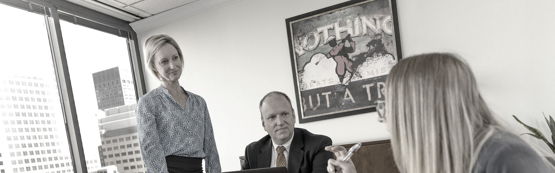 two women and a man meeting in a downtown St. Louis office building