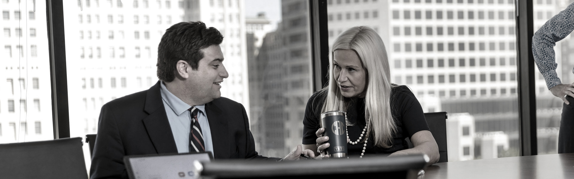 a man and woman having a conversation at a conference table